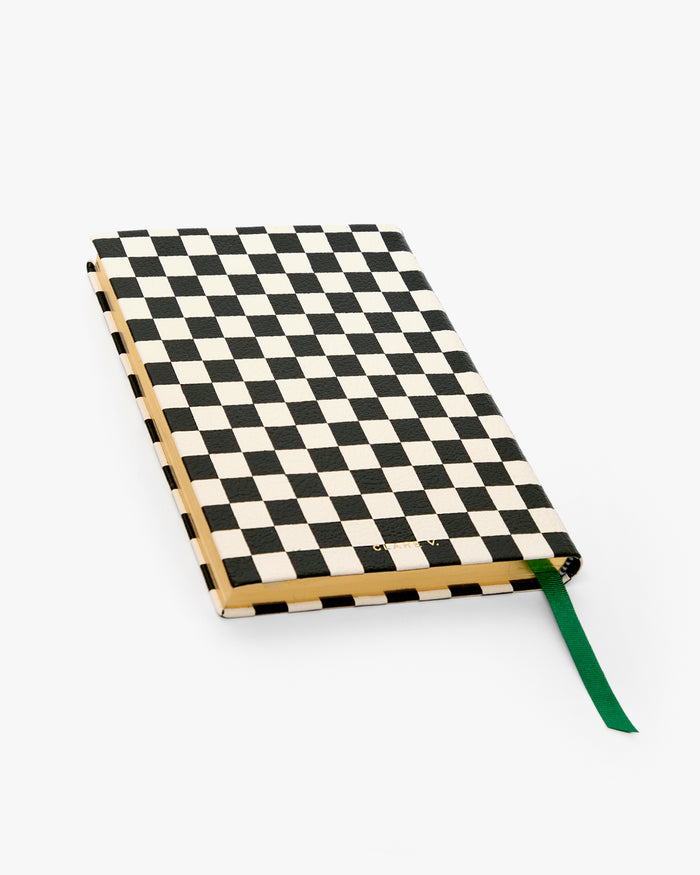Back of the Black and Cream Checkered Notebook with emerald ribbon bookmark sticking out.